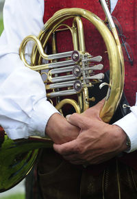 Midsection of man playing guitar