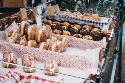 Variety of fresh doughnuts, muffins and pastries on sale at a food market in london, uk.