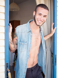 Close-up portrait of happy man standing at doorway