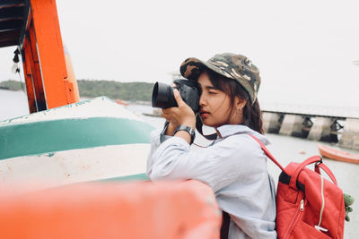 Close-up of woman photographing outdoors