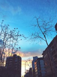 Low angle view of city against sky during sunset