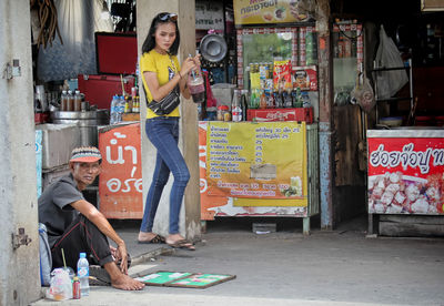 Portrait of friends standing at market