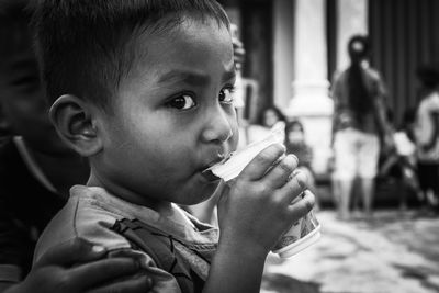 Close-up portrait of boy eating ice cream