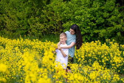 Close-up of yellow flowering plants on field