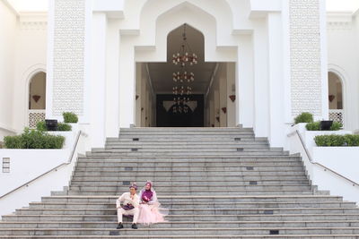 Low angle view of people on staircase outside building