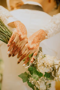 Close-up of woman holding white flower