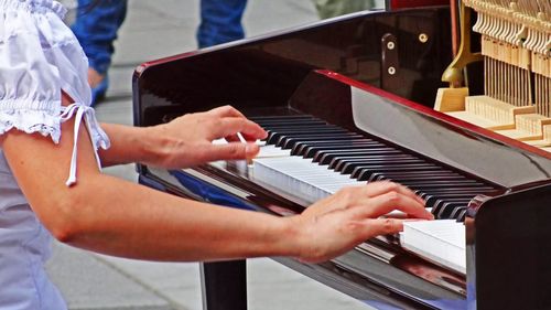 Midsection of woman playing piano