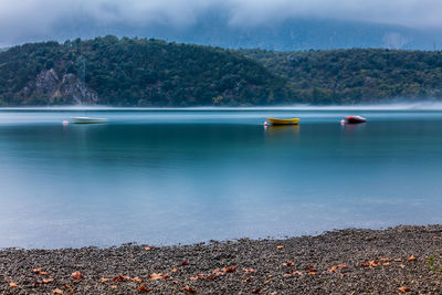 Scenic view of lake by mountain against sky