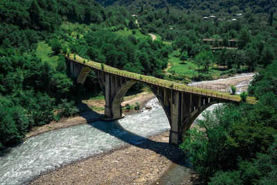 Bridge over river against mountain
