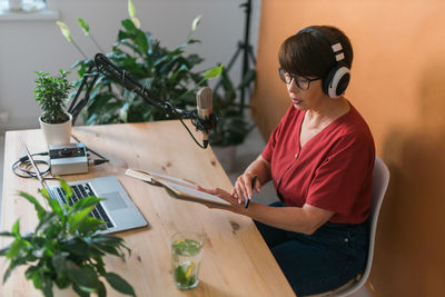 Senior woman broadcasting at studio