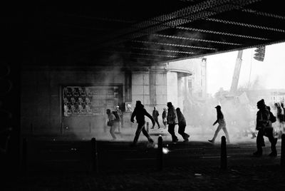 Silhouette people walking on road