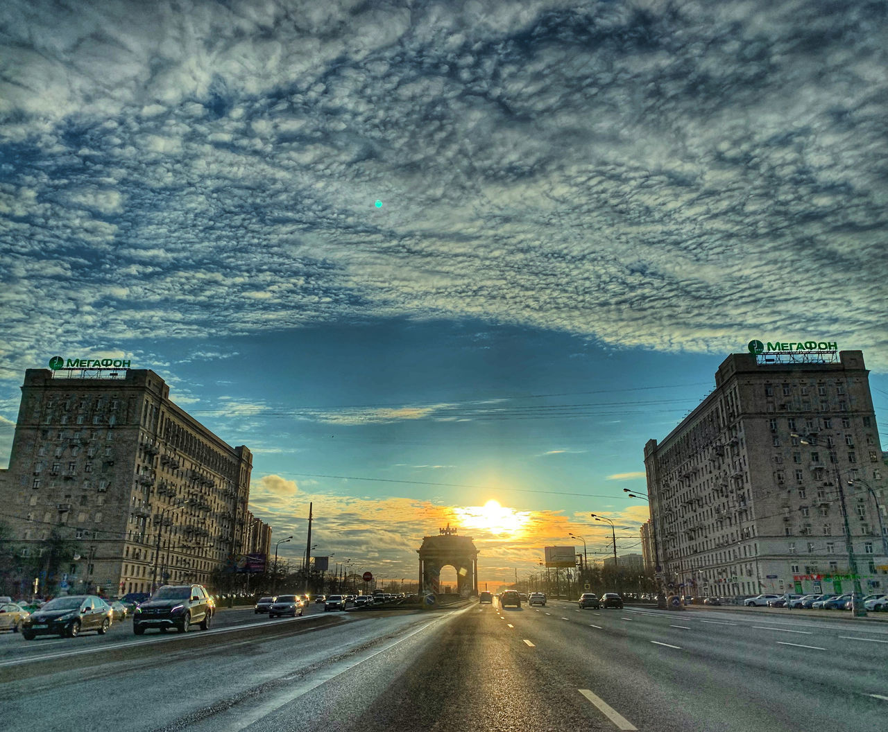 TRAFFIC ON CITY STREET AGAINST SKY