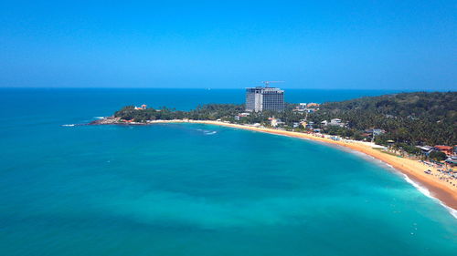 Scenic view of sea against clear blue sky