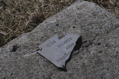 High angle view of text on rock