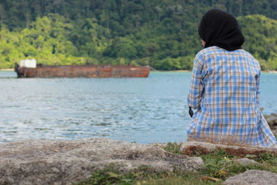 Rear view of couple standing by trees