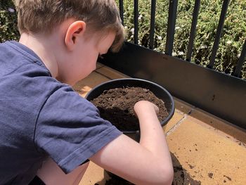 Side view of boy looking through man