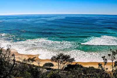 High angle view of sea against clear blue sky