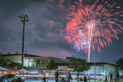 People watching fireworks at night