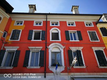 Low angle view of red building against sky