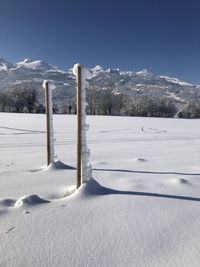 Snow covered landscape against sky