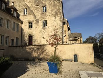 Footpath by building against sky