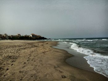 Scenic view of beach against clear sky