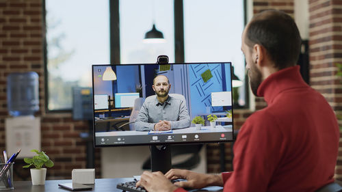Businessman having video call on desktop pc at office