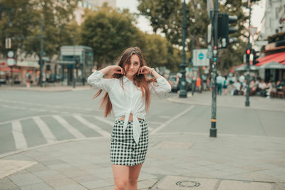 Portrait of woman standing in city