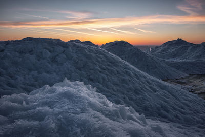 Scenic view of mountains against sky during sunset