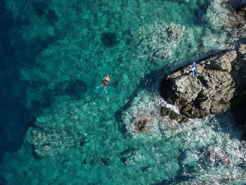 High angle view of people swimming in sea