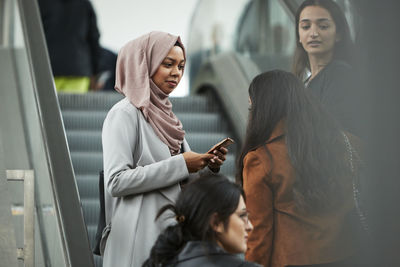 Smiling female friends talking together