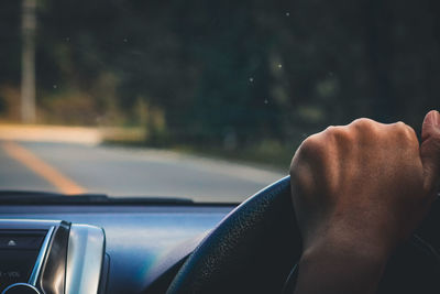 Midsection of man in car