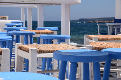 Chairs and tables at restaurant at paros