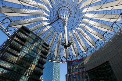 Low angle view of modern office building against blue sky