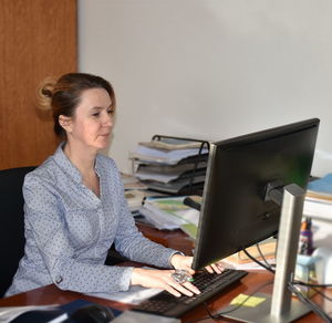 Woman using computer at office