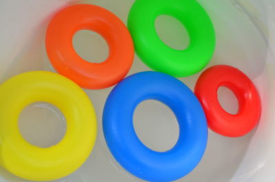 High angle view of colorful inflatable rings floating in pool