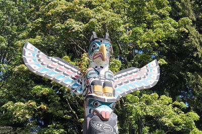 Low angle view of statue against trees