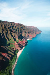 Scenic view of rock mountains by sea