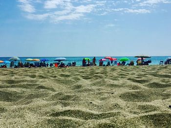 Scenic view of beach against blue sky