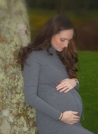 Beautiful young woman standing in park