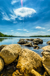 Rocks on sea shore against sky