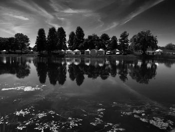 Reflection of trees in lake against sky