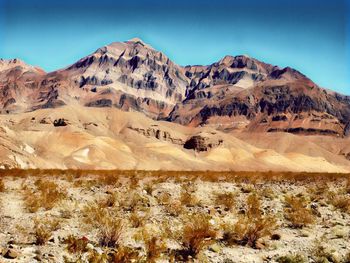 Scenic view of snowcapped mountains against blue sky