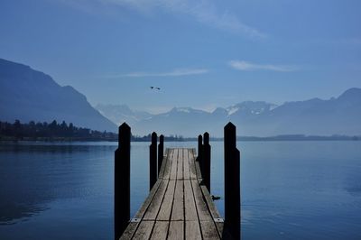 Pier over lake against sky