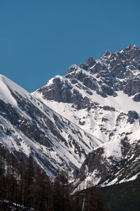 Scenic view of snowcapped mountains against clear blue sky