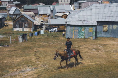 A young boy rides a horse.  adjara region of  georgia