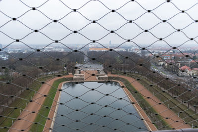 Close-up of chainlink fence against building