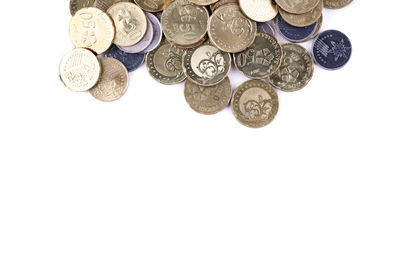 High angle view of coins on white background