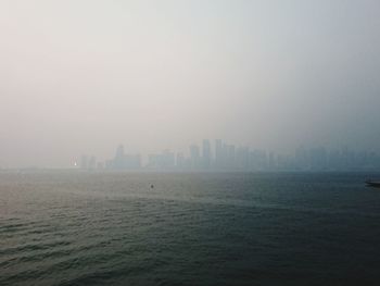 Scenic view of sea and buildings against sky