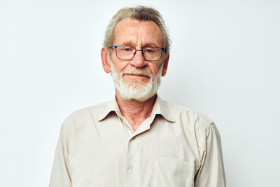Portrait of senior man against white background